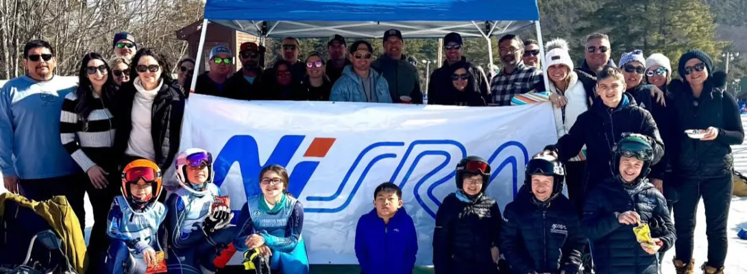 Racers posing in front of NJSRA banner