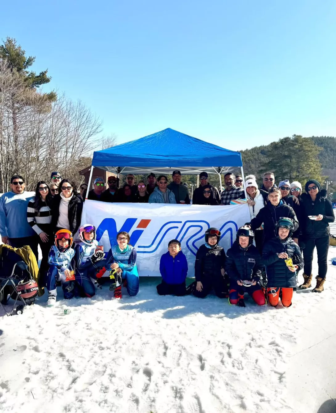 Racers posing in front of NJSRA banner